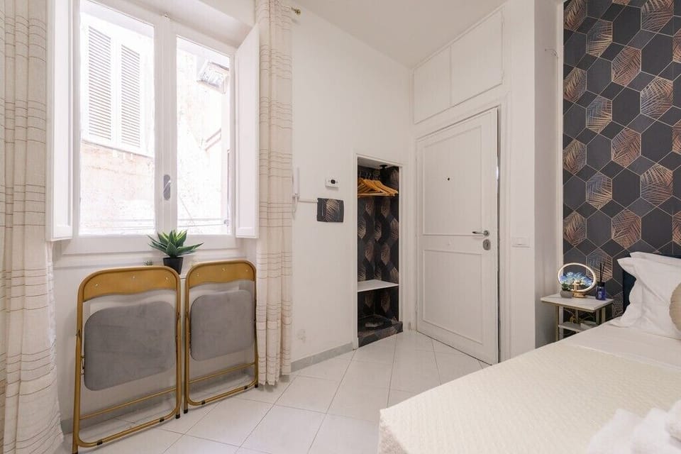right boutique-style room with comfortable bedding and chic décor.

