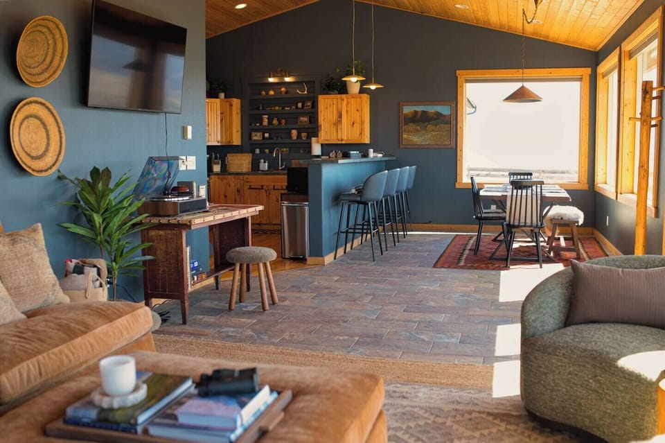 Expertly designed living room, dining area, and kitchen for all to gather.
