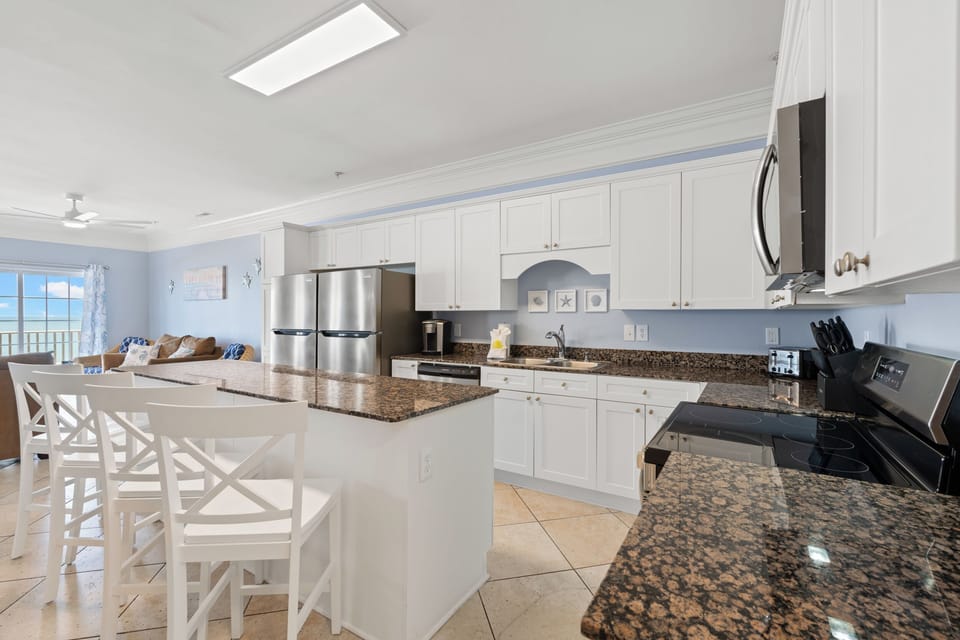 Kitchen with 2 full size refrigerators and island seating