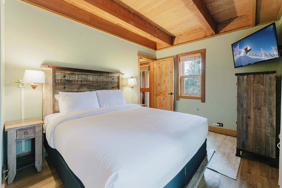 The primary queen suite boasts a smart TV, balcony, & an ensuite bath​