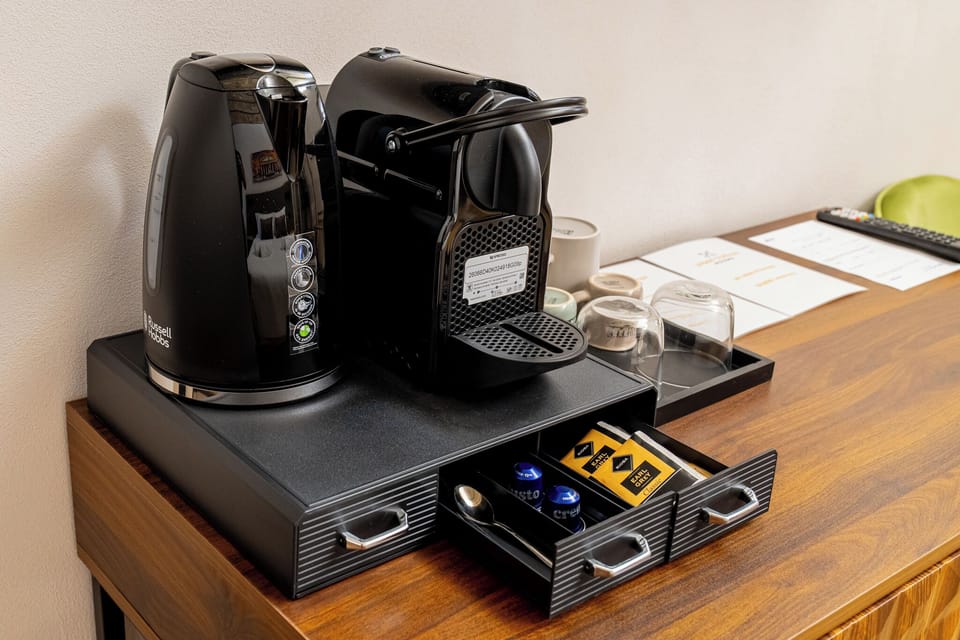 Deluxe Triple Room, Courtyard View | Coffee and/or coffee maker