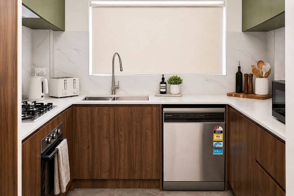Functional kitchen featuring modern appliances, generous workspace, and easy clean-up facilities, ideal for guests who enjoy cooking during their stay.