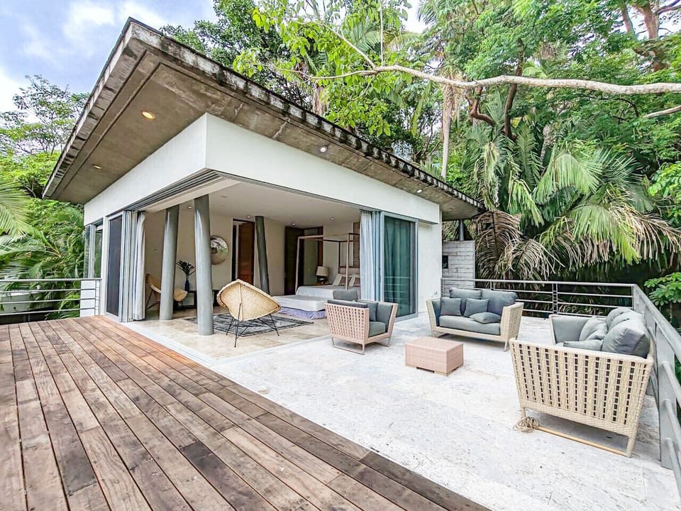 Very spacious ocean & jungle-view terrace with comfy outdoor lounge seating and direct bedroom access—perfect for sunrise coffee, sunset cocktails, and relaxing in quiet Puerto Vallarta.