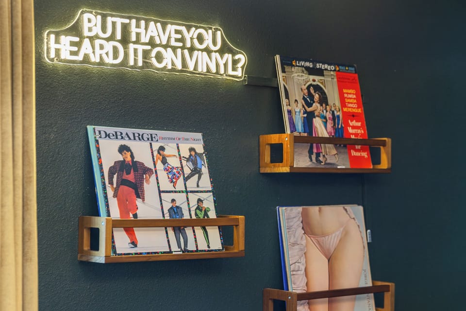 Neon vinyl wall display with curated record shelves