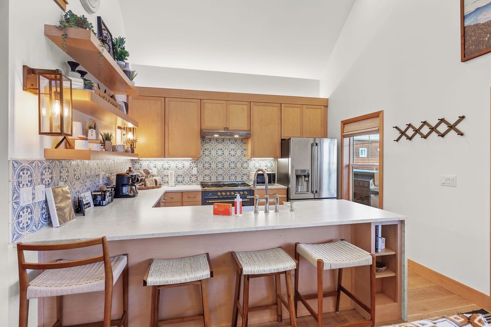 The island seats four and is perfect for casual meals, morning coffee, or keeping the cook company.
