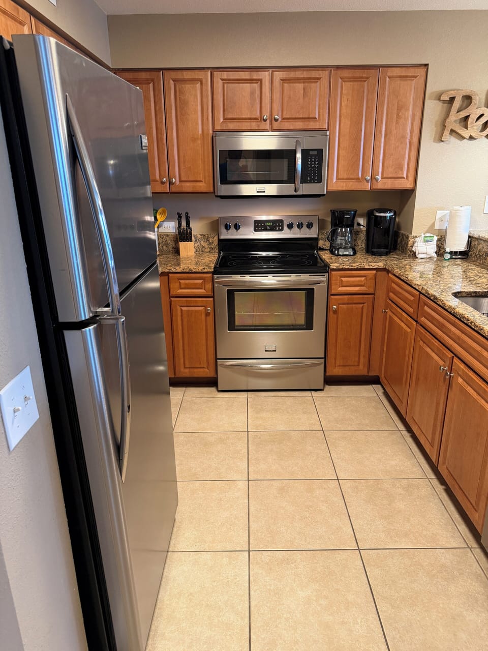 Your fully equipped kitchen awaits with sleek stainless appliances, warm wood cabinets, and granite counters for memorable meal prep.