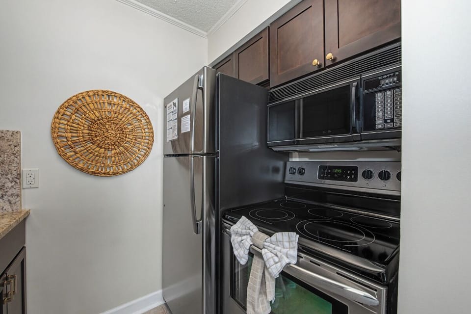 Your fully equipped kitchen features stainless appliances, a microwave, stove, and all the essentials you'll need to prepare delicious meals during your stay.