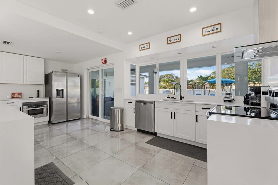 High-end kitchen finishes including a professional-grade range and coffee station.