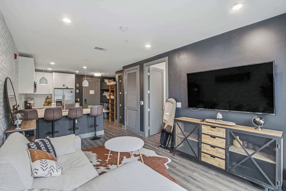 Living Room, experience modern comfort with chic decor and open kitchen views! Perfect for relaxation!