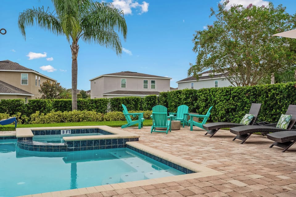 Private pool and spa with sunny patio, loungers, and outdoor seating
