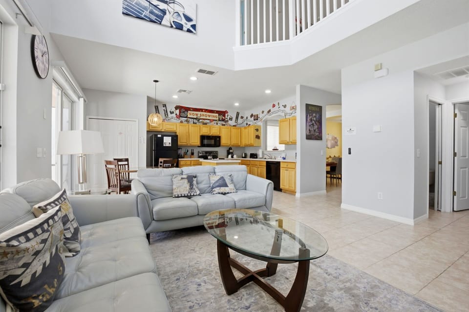 Expansive main living room with soaring ceilings and direct access to the pool