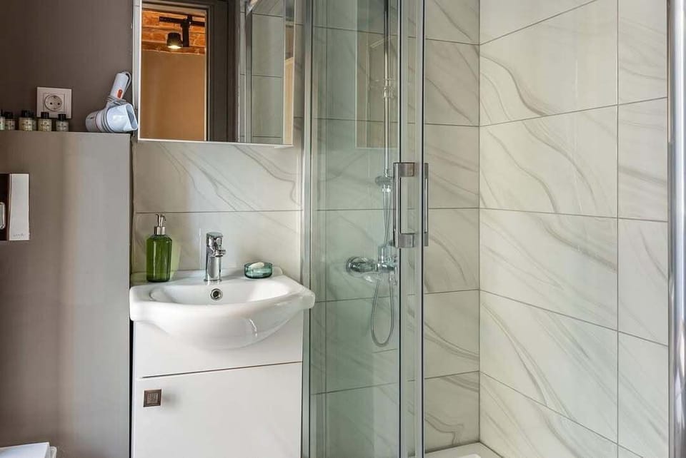Superior Triple Room, City View | Bathroom | Hair dryer, slippers, towels, soap