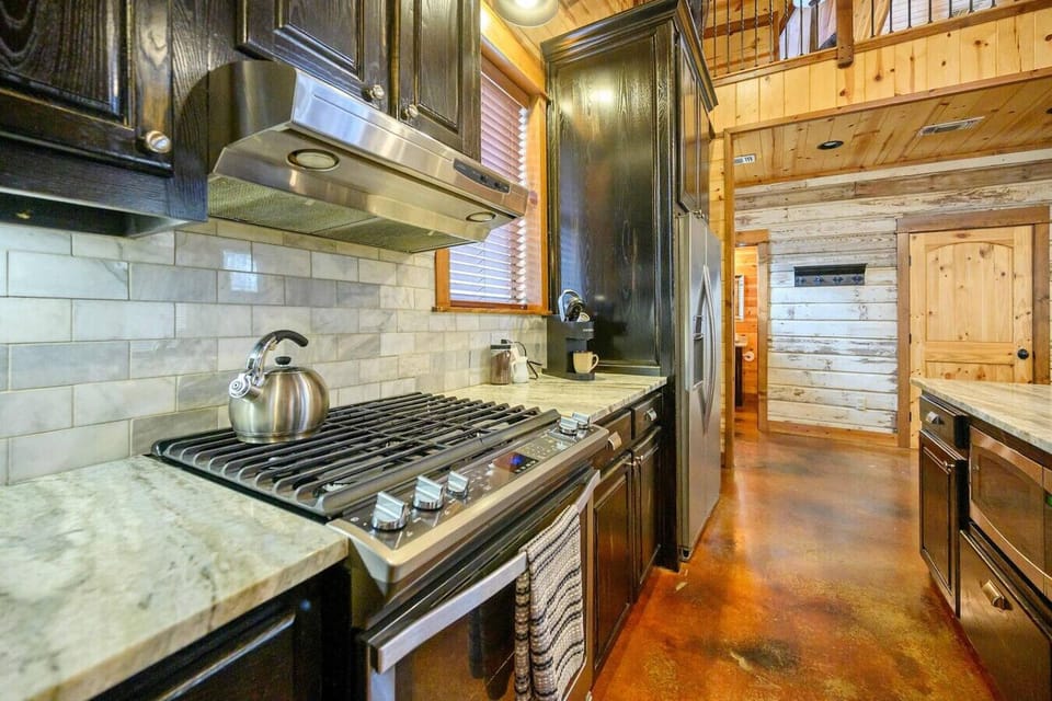 Well-equipped kitchen with gas range & marble countertop