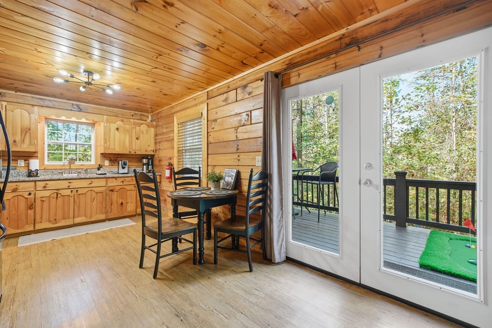 Charming dining area with French doors leading to the outdoor deck.