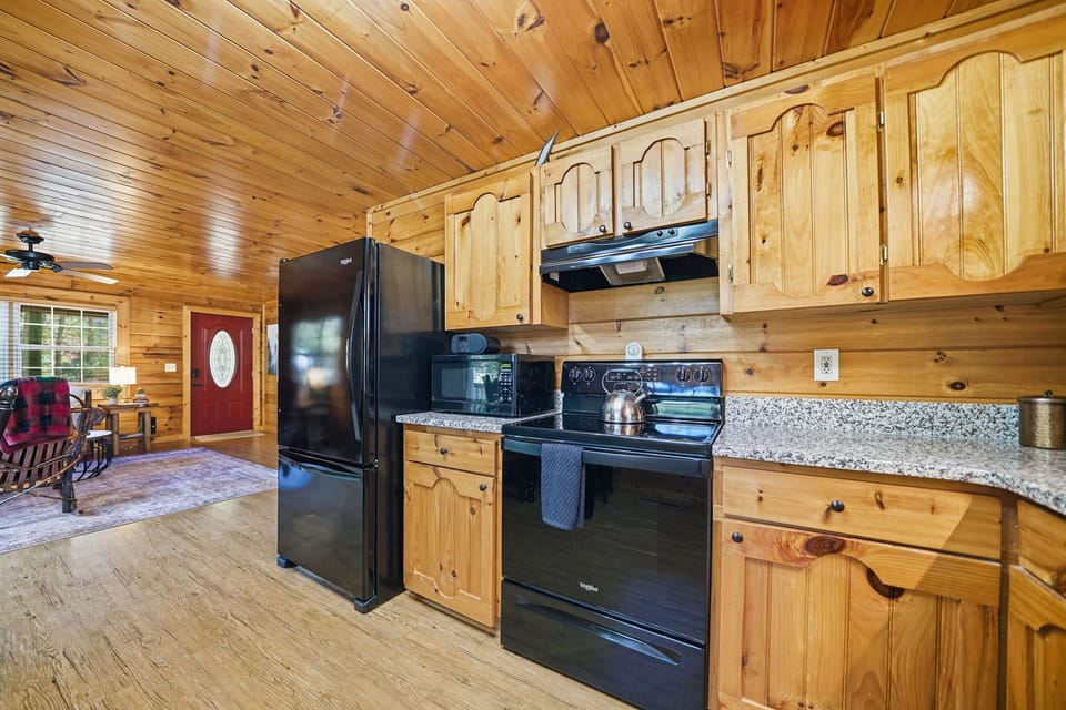 Rustic-style kitchen with natural wood cabinetry and modern appliances.