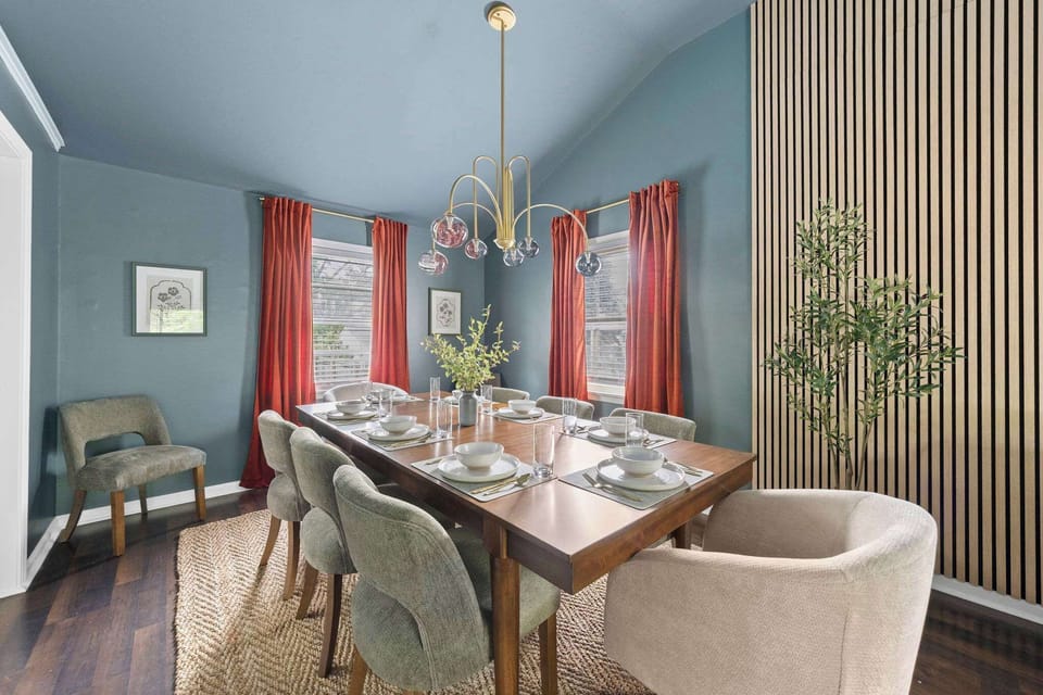 Bright dining area w/ a round table, mixed seating & warm, inviting tones.

