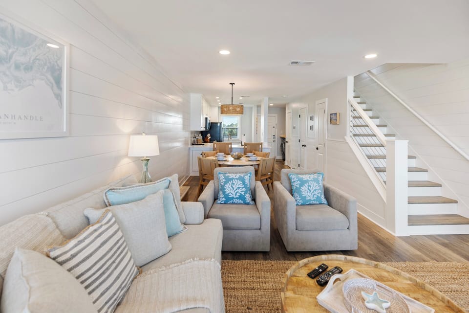 Relax in your bright, coastal-inspired living space where soft blues meet warm grays and natural textures create the perfect seaside retreat.