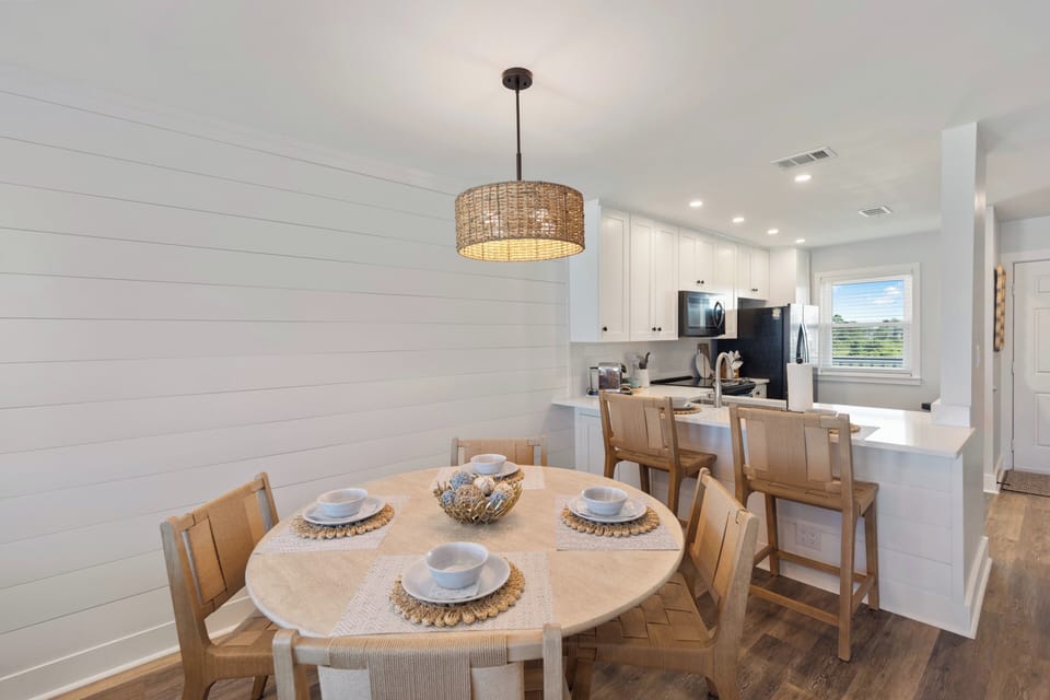 Your stylish dining space flows seamlessly into the modern kitchen, creating the perfect setting for memorable meals and morning coffee.