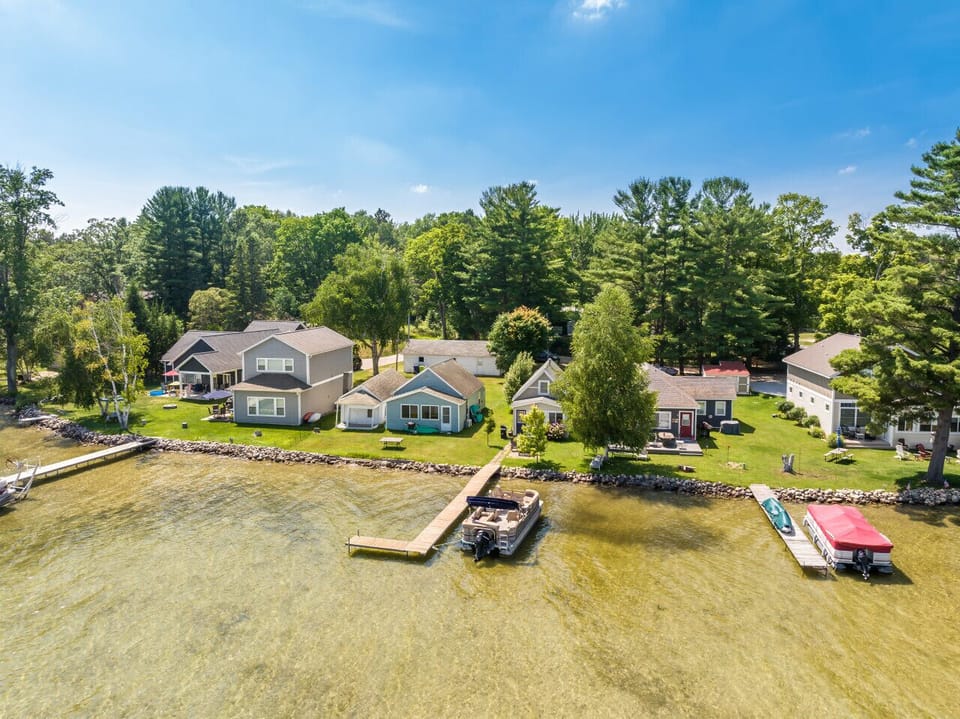 Aerial view of property, dock, and neighbors