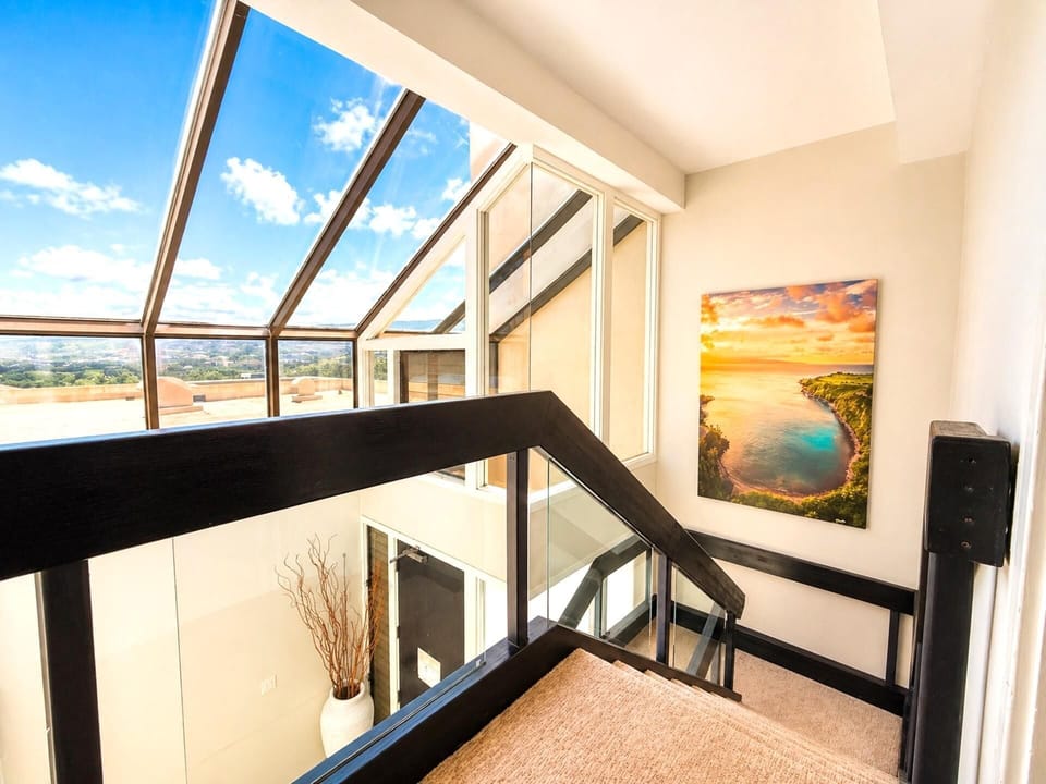 A welcoming entryway with artwork and above head windows