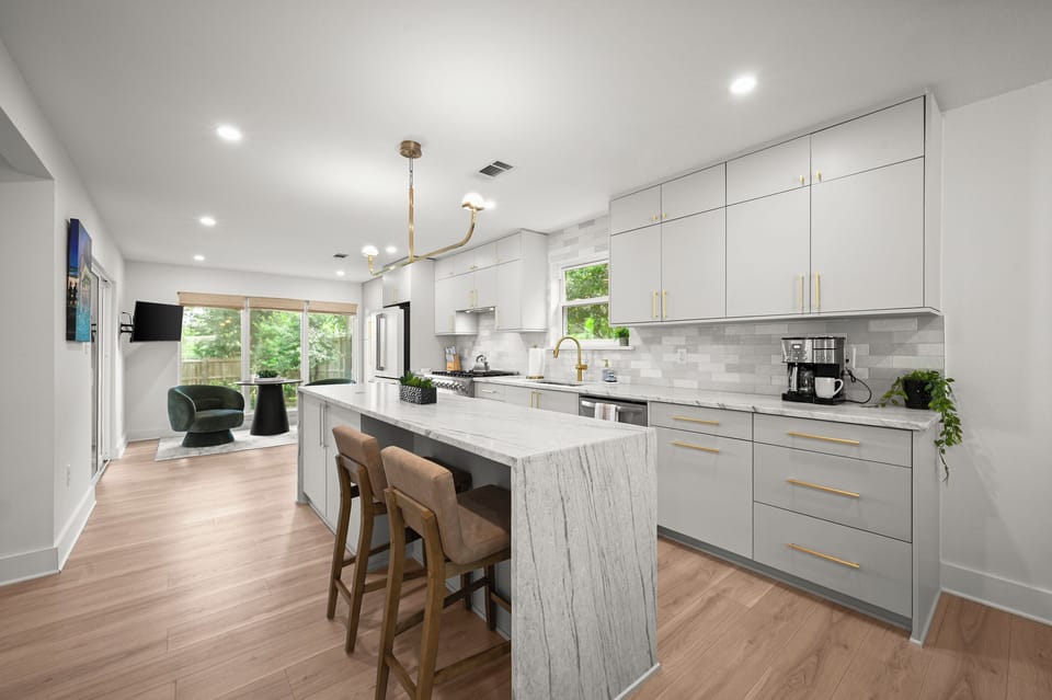 Another view of the bright, fully equipped kitchen with plenty of space to cook and gather.