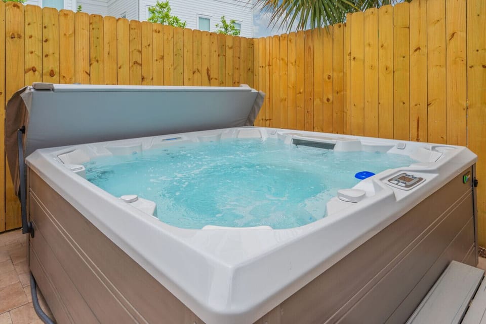 Relax under the open sky in a soothing and tranquil hot tub setting.