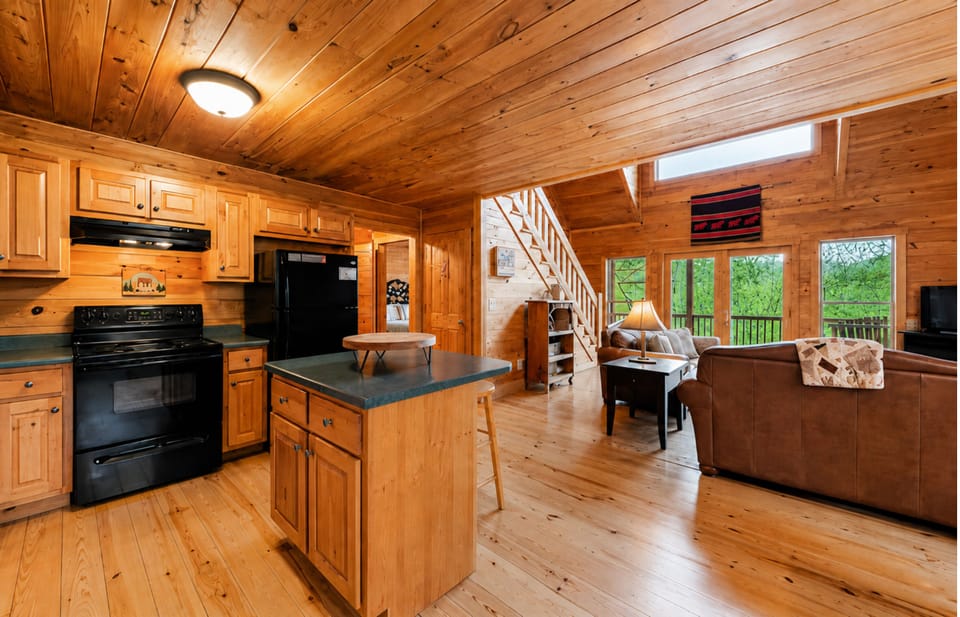 Bright mountain cabin kitchen with open living space views