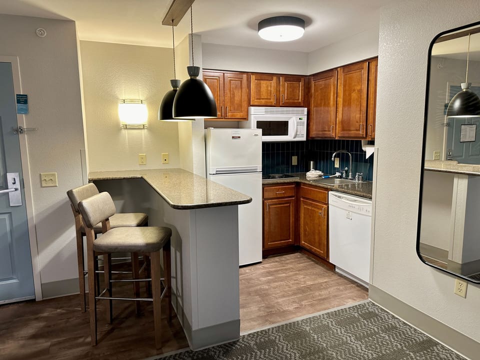 Suite kitchen with full appliances and dining bar.