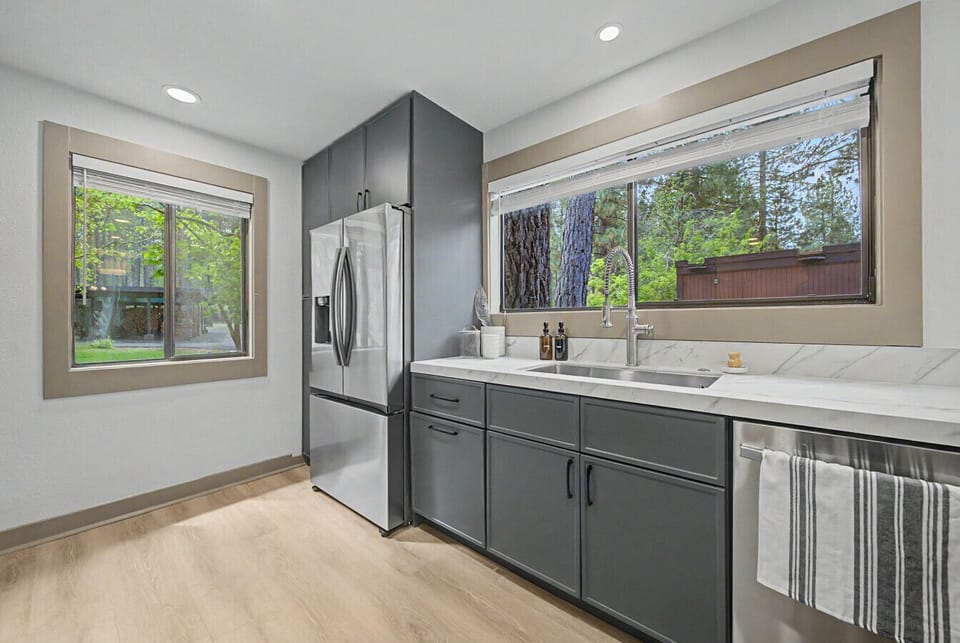 Top-of-the-line new appliances throughout — refrigerator, range, microwave, and dishwasher.