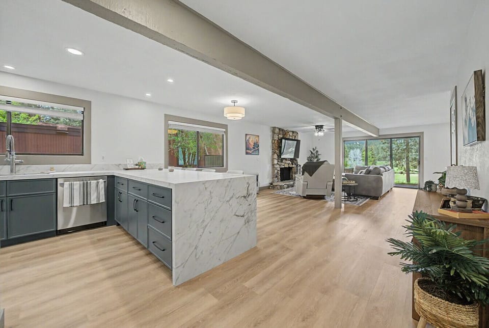The open concept living area flows seamlessly between the kitchen, living and dining areas- perfect for connecting with your group