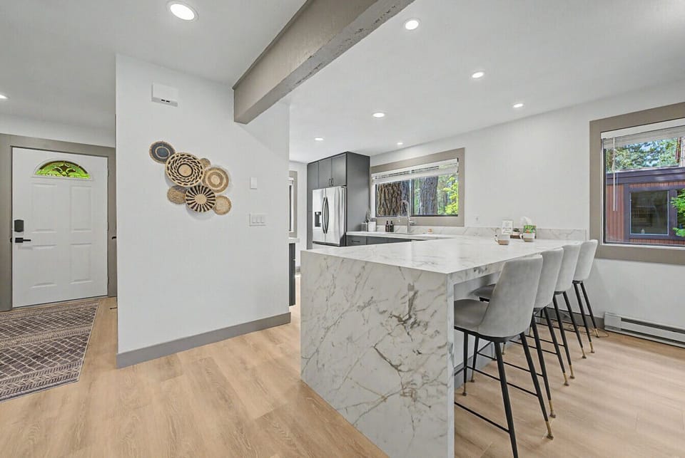 The waterfall countertop bar is a design moment — and it seats four for casual dining or morning coffee.