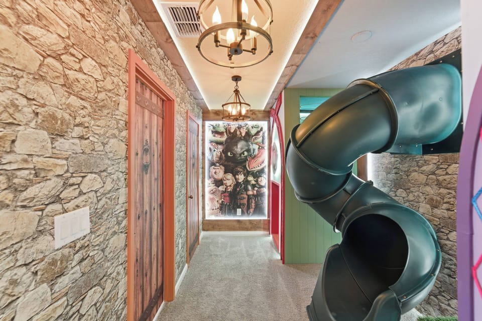 Let kids dream in a How to Train Your Dragon themed bedroom with castle details, a fun indoor slide, cozy bunk-style beds, warm lighting, and playful Viking décor.