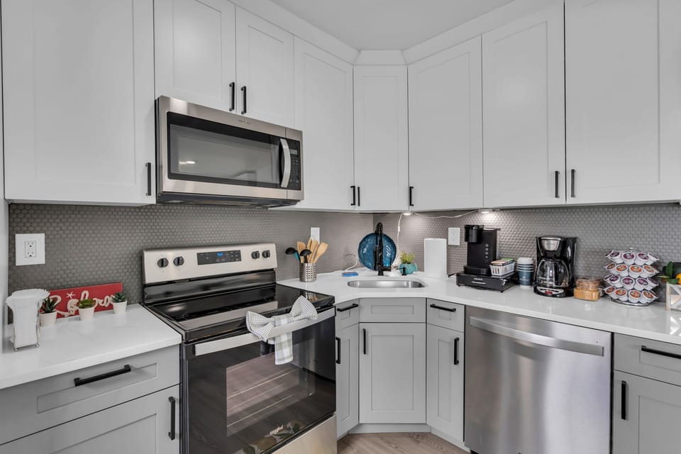 Modern kitchen with stainless appliances and stocked coffee bar