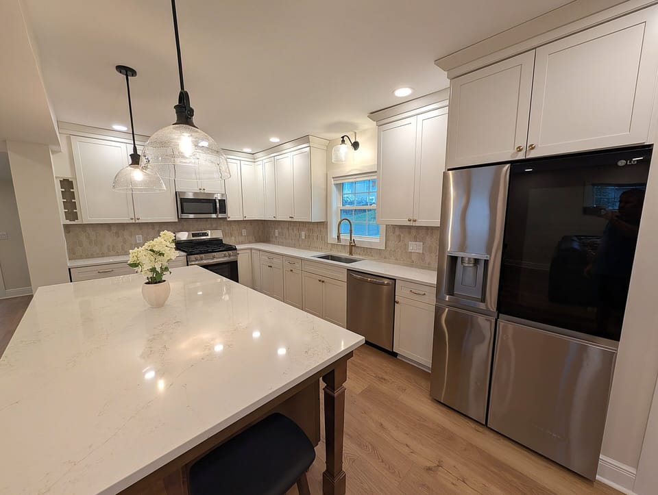 Large modern kitchen with quartz island and stainless appliances