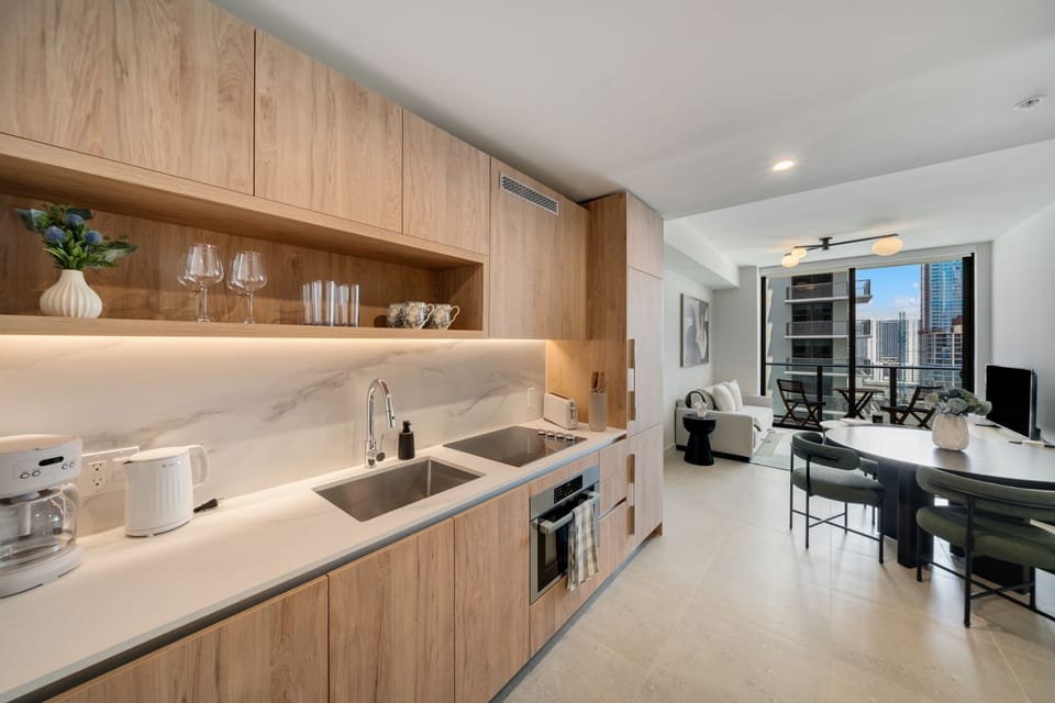 Modern kitchen area flowing into the living and dining space.