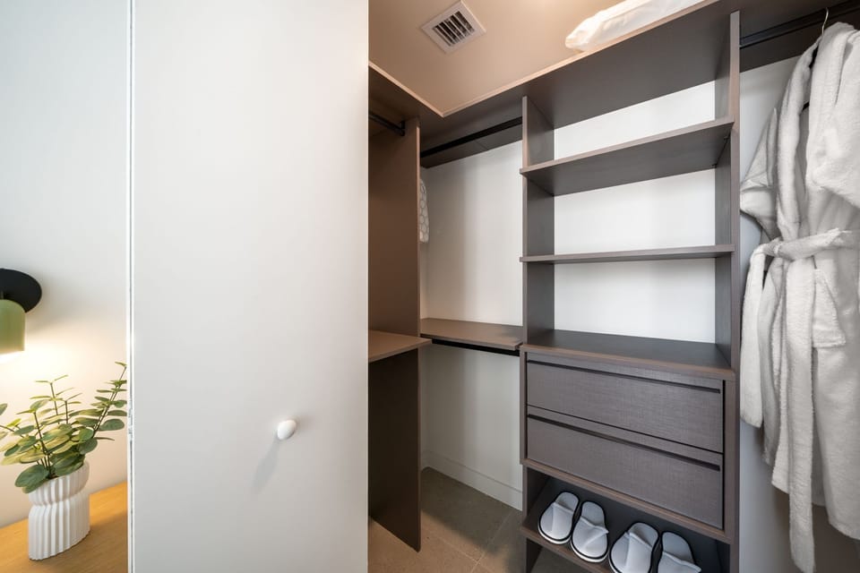 Spacious closet with built-in shelving, drawers, and hanging space.