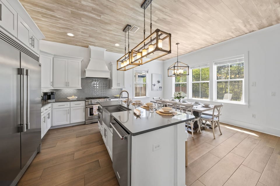 Four island stools, pendant lighting, and a kitchen built for the whole group — breakfast never looked so good.
