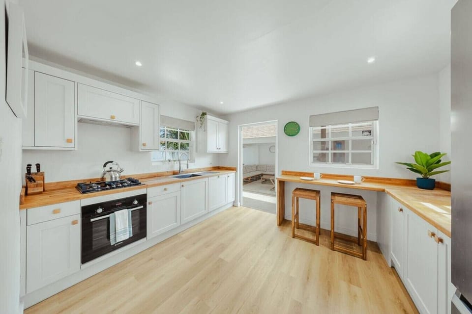 Fully equipped kitchen with plenty of counter space, a breakfast bar, and everything you need for easy home-cooked meals, quick snacks, or morning coffee before heading out.