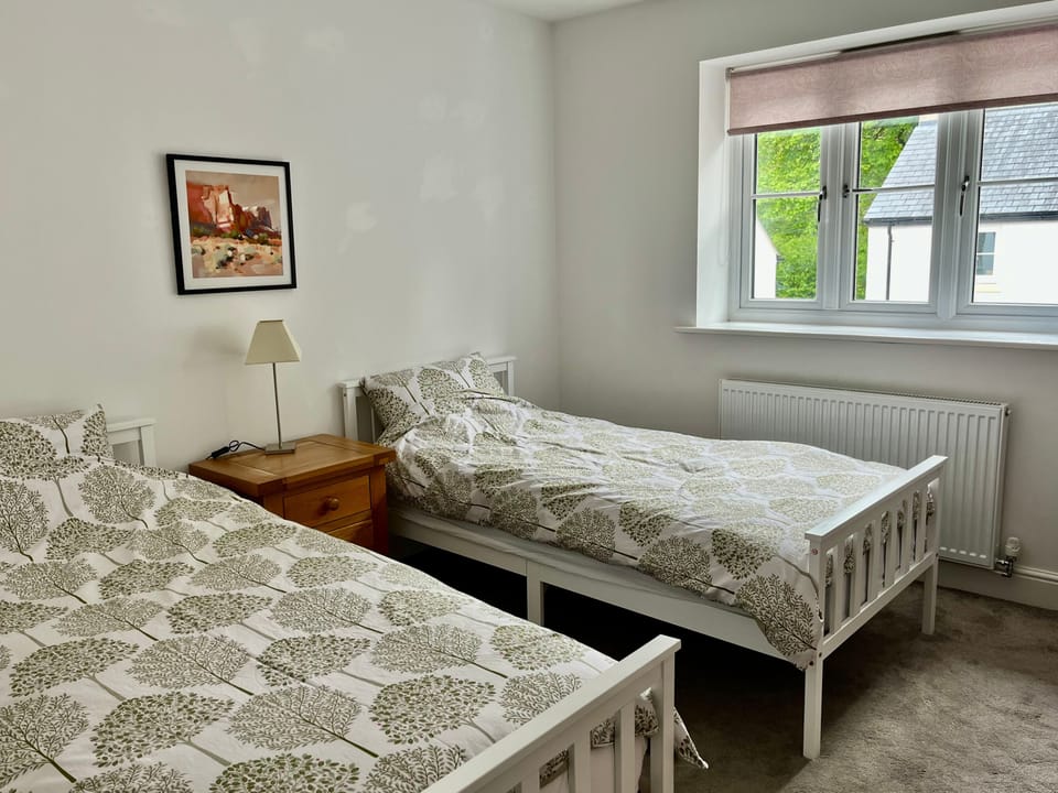 Bright twin room with woodland view