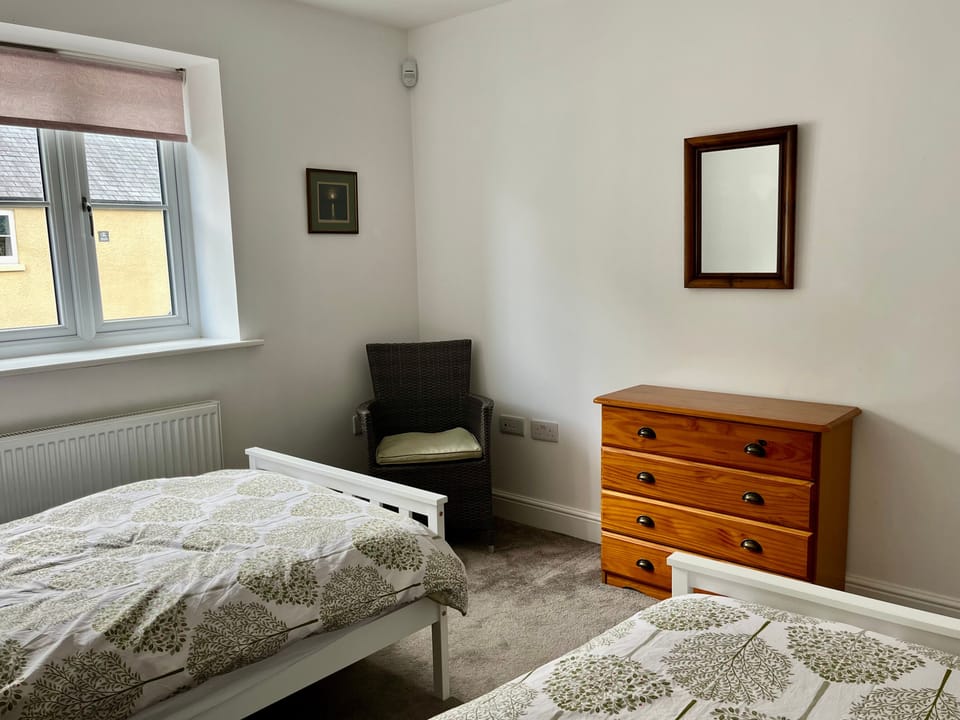 Twin room with seating and storage