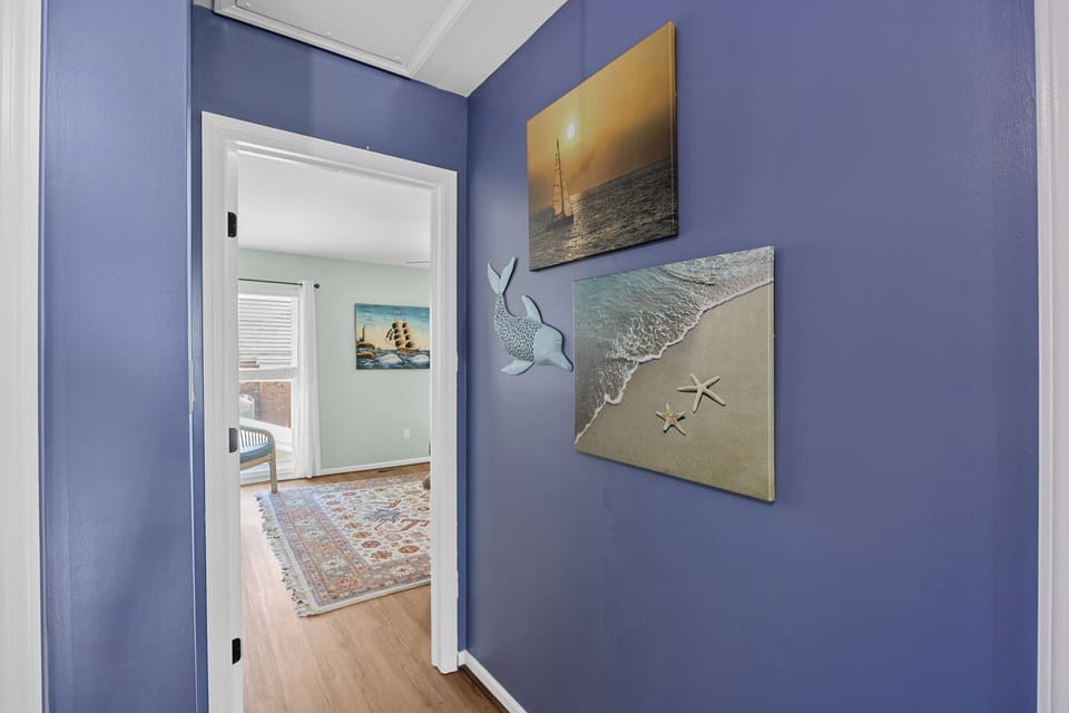 The cozy open-concept living space is filled with natural light, creating a warm and inviting atmosphere ideal for extended stays or weekend beach getaways.