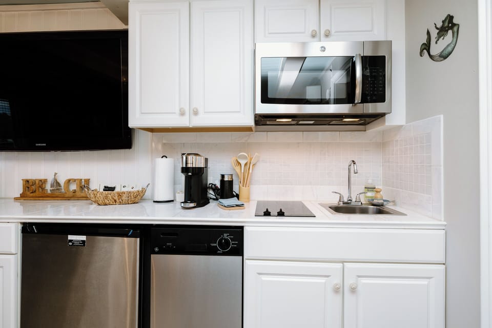 The fully equipped kitchen includes everything needed for preparing meals, beach snacks, and morning coffee during your stay.