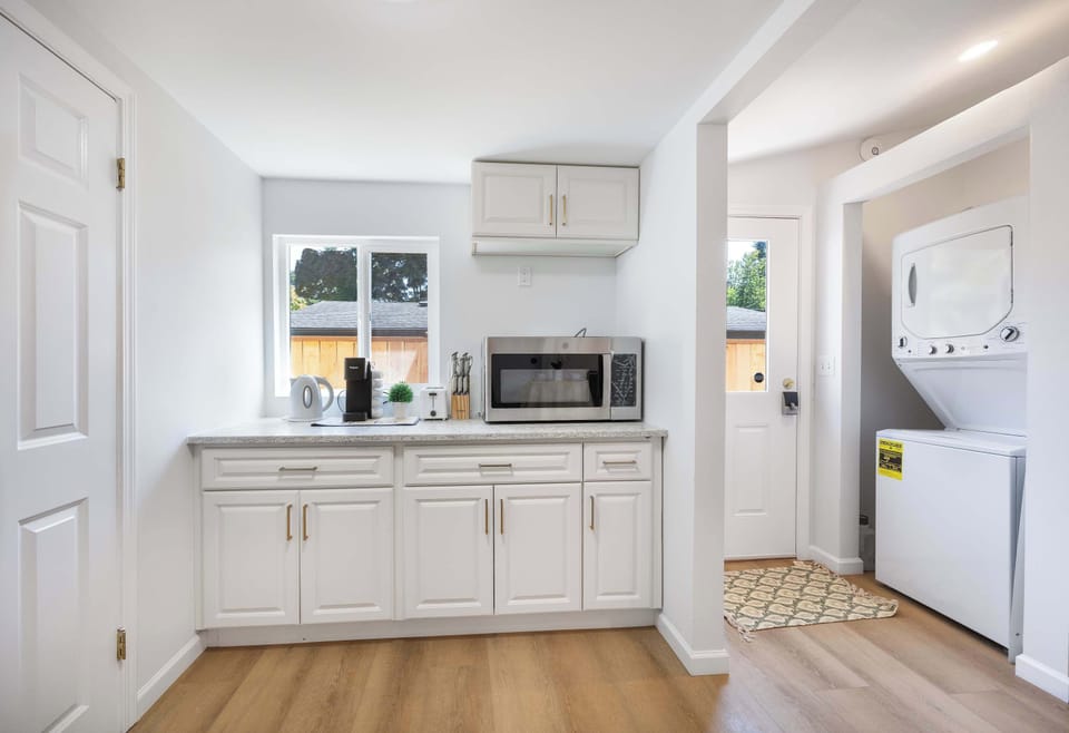 Bright utility area with in-unit washer/dryer and a convenient sink for added functionality.