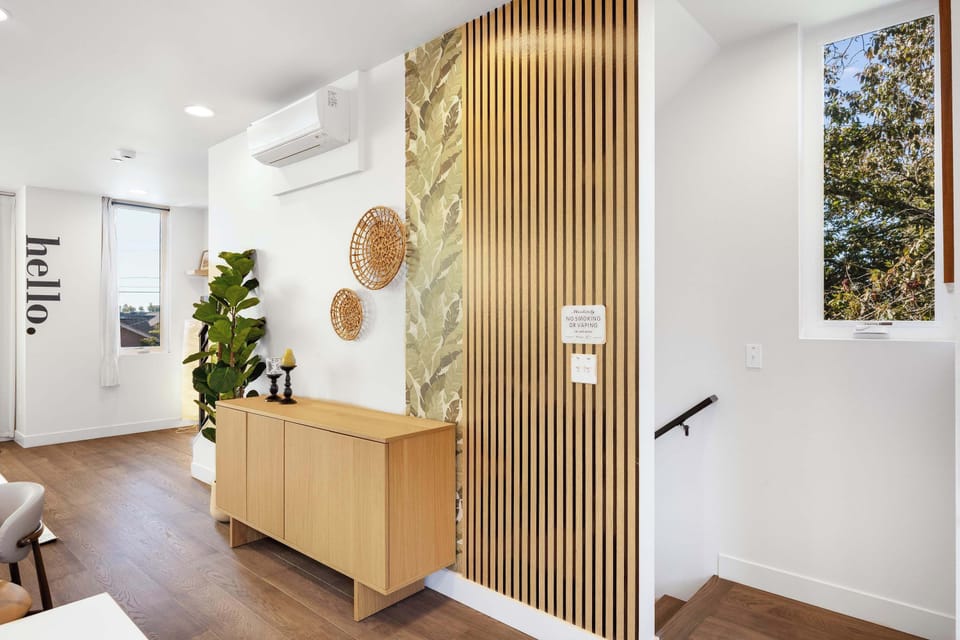 Warm wood accents and woven details add a touch of natural charm to the entryway.