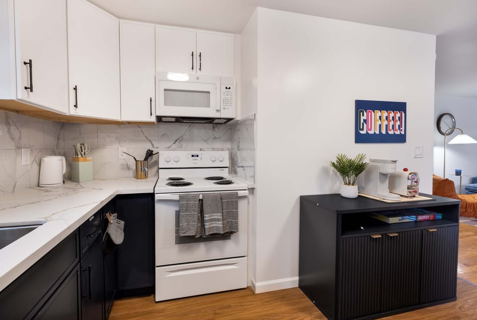 Fully equipped kitchen with modern finishes and a dedicated coffee station.