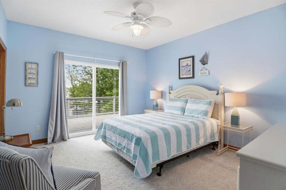 Upper/main level queen guest room, to the left of the hallway just past the hall bath. Lakeside, exits out onto the patio.