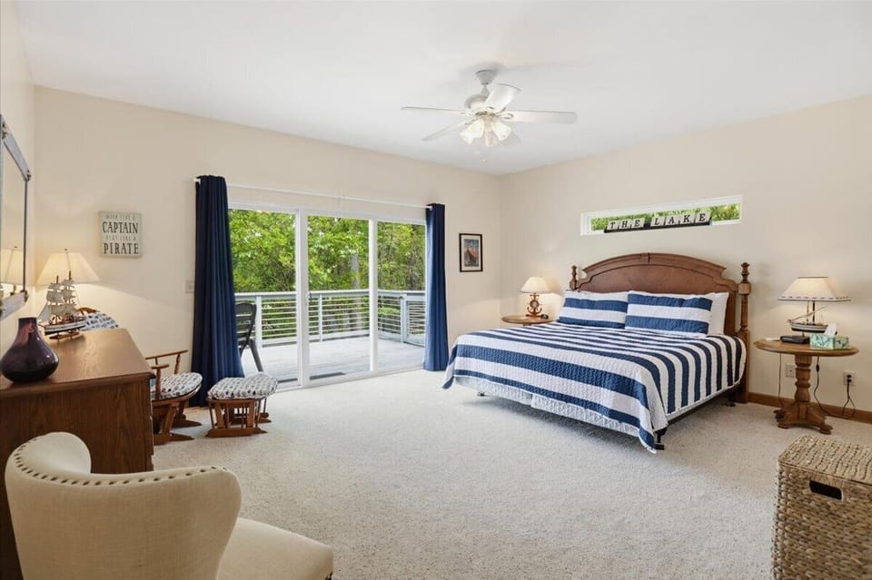 Upper/main level king ensuite bedroom, at the end of the hallway. Exits out onto the patio, lakeside.