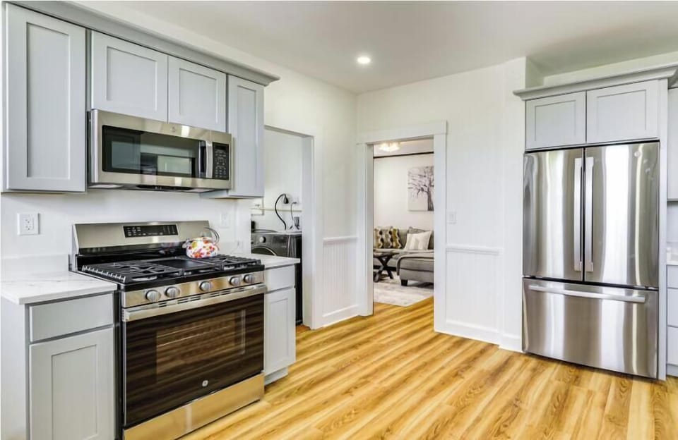  A fully equipped kitchen with a conveniently located laundry room just off to the side, designed for comfort and ease during your stay.