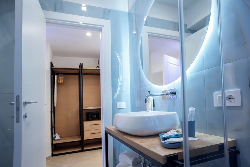 Deluxe Triple Room, 1 Queen Bed, Balcony, City View | Bathroom | Shower, rainfall showerhead, hair dryer, slippers