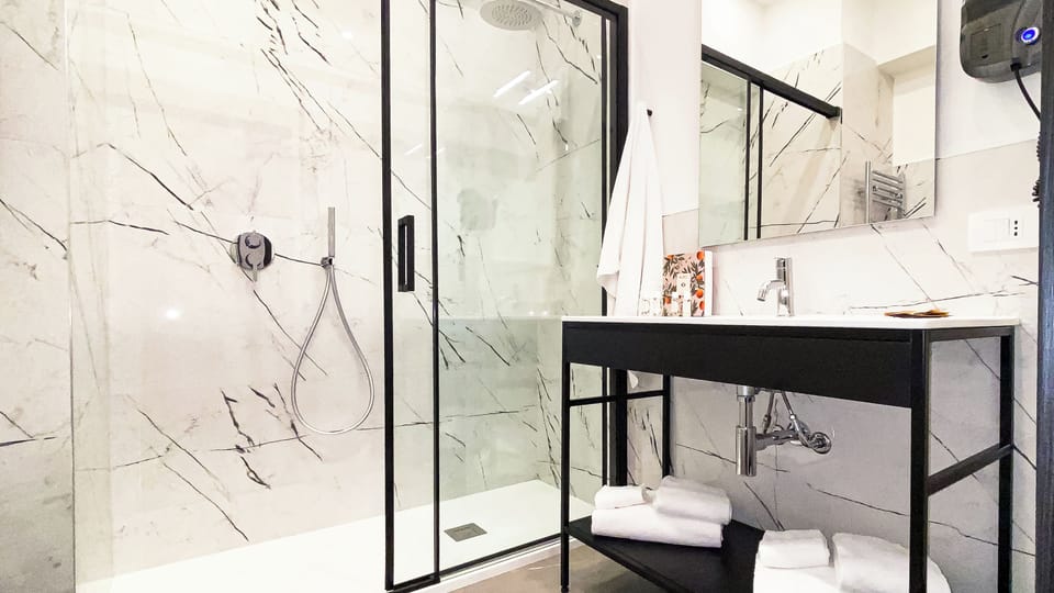 Superior Quadruple Room, City View | Bathroom | Shower, hair dryer, towels, soap